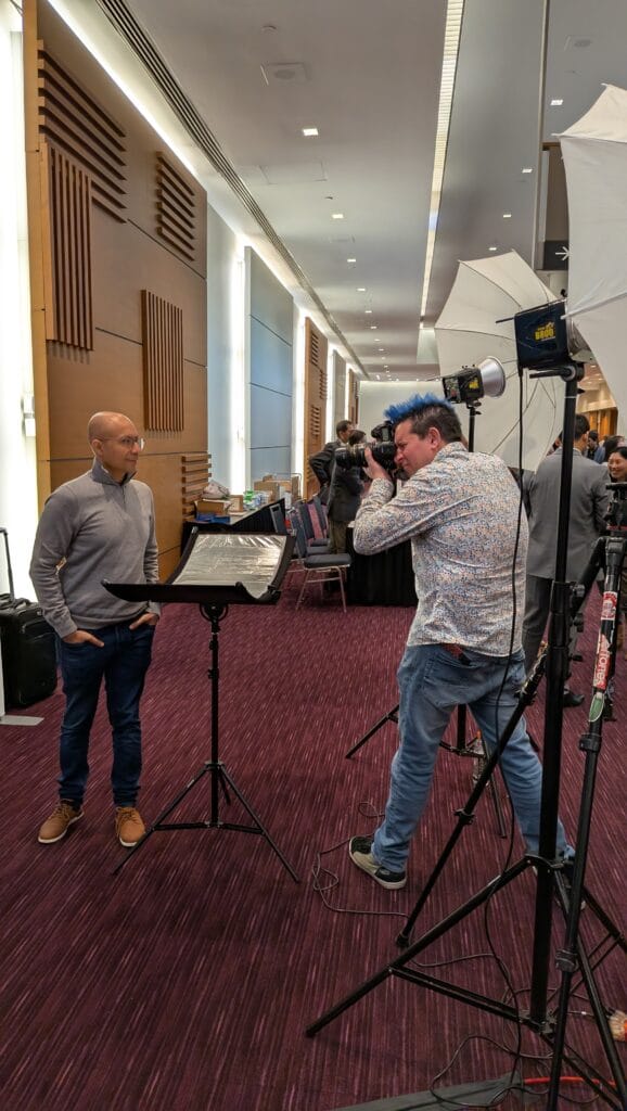 Professional headshot station setup at the TD Financial Conference with branded backdrop and professional lighting