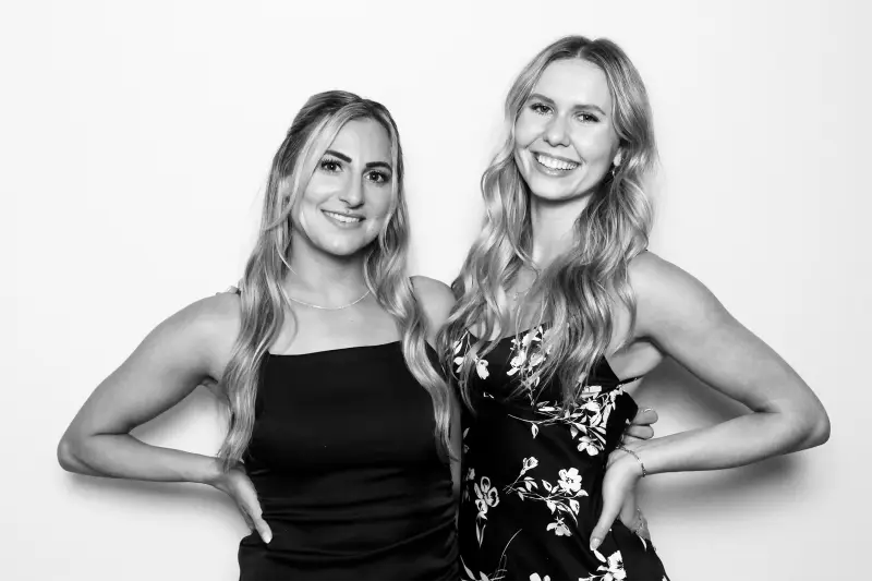 Guests stepping into a Booth Empire glam photo booth at an event